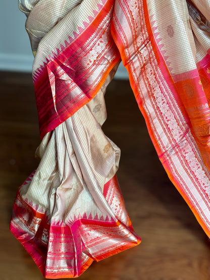 Handwoven Kuttu Gadwal pure Silk Saree in Beige color with orangish peach Checks body