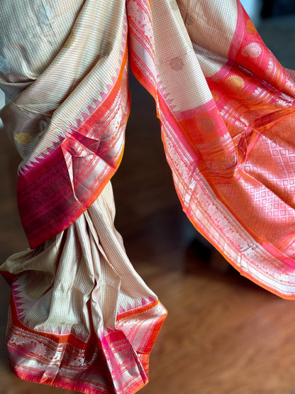 Handwoven Kuttu Gadwal pure Silk Saree in Beige color with orangish peach Checks body