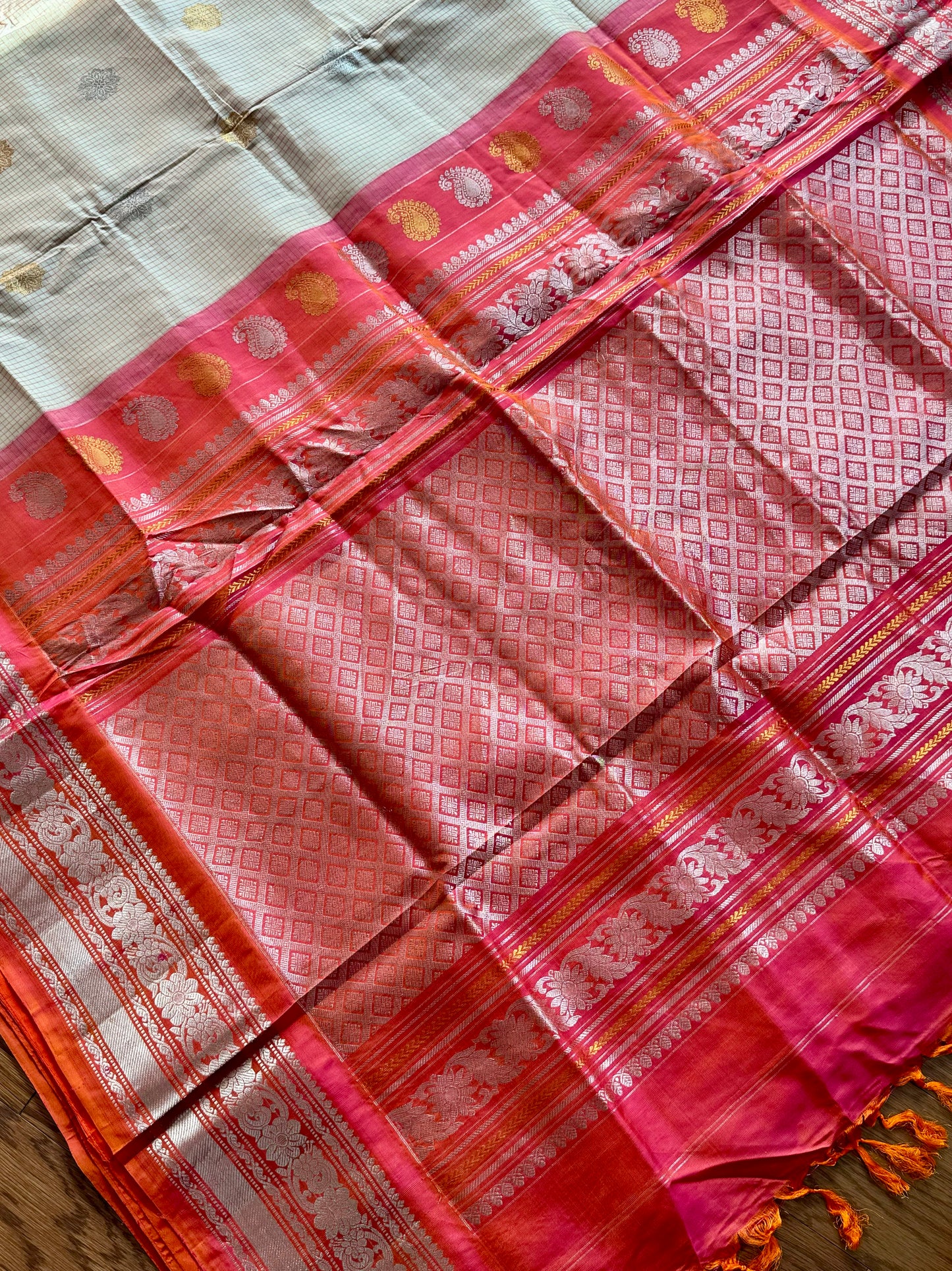 Handwoven Kuttu Gadwal pure Silk Saree in Beige color with orangish peach Checks body