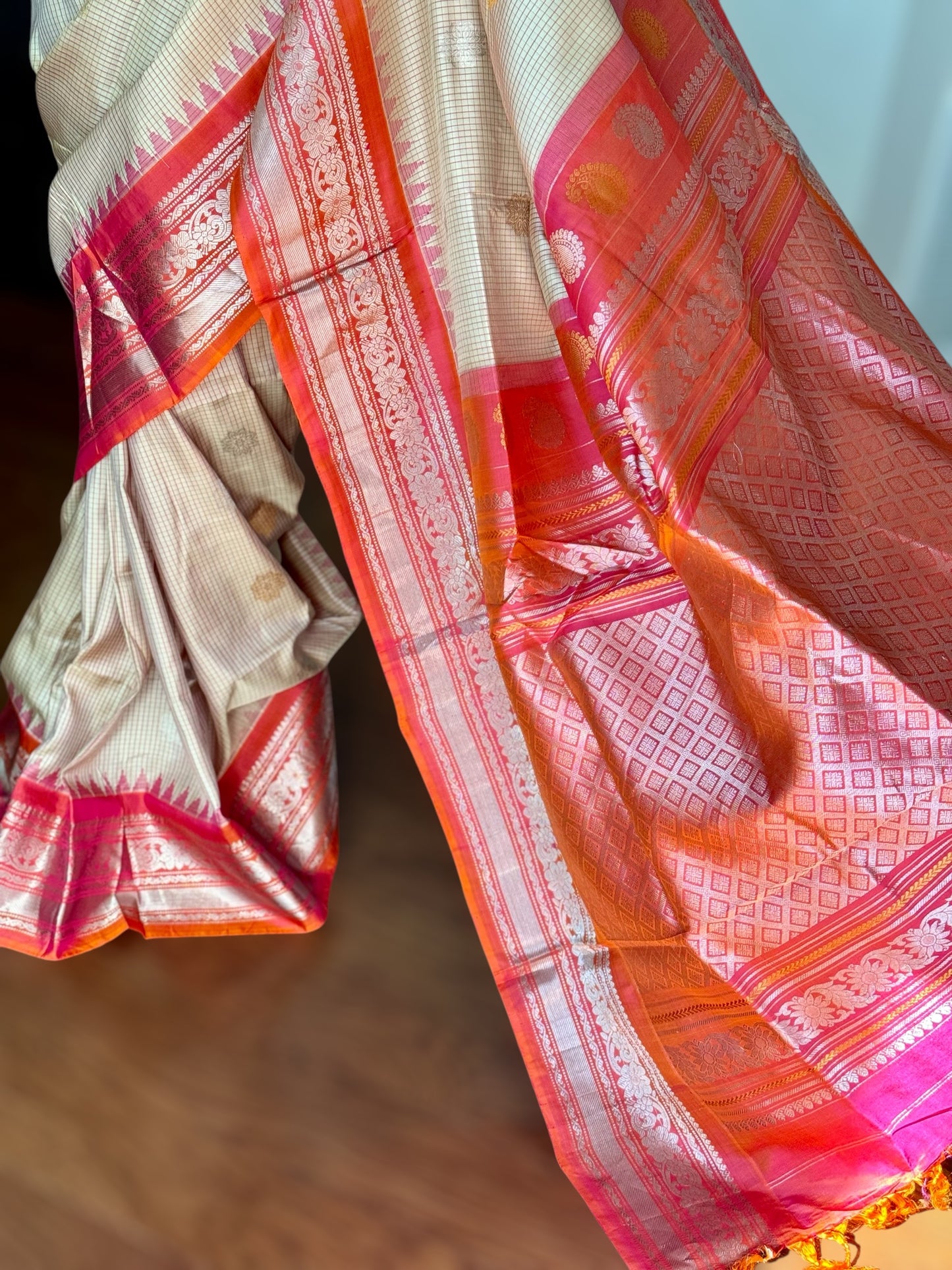 Handwoven Kuttu Gadwal pure Silk Saree in Beige color with orangish peach Checks body