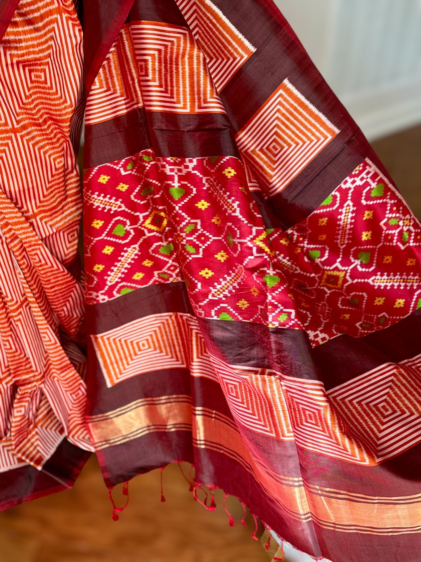 Orange and Brown combination Contemporary ikat pure silk saree with mirror effect body design