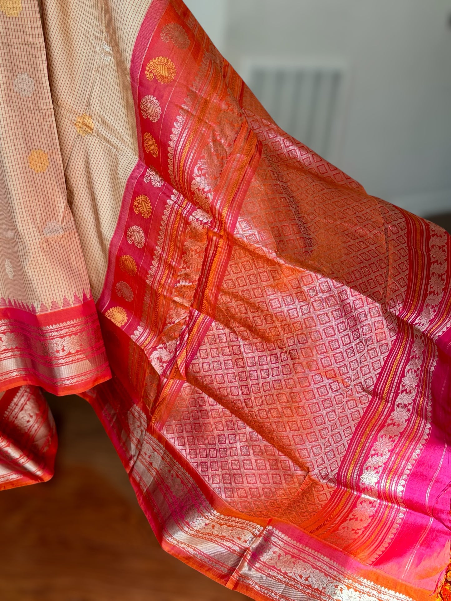 Handwoven Kuttu Gadwal pure Silk Saree in Beige color with orangish peach Checks body