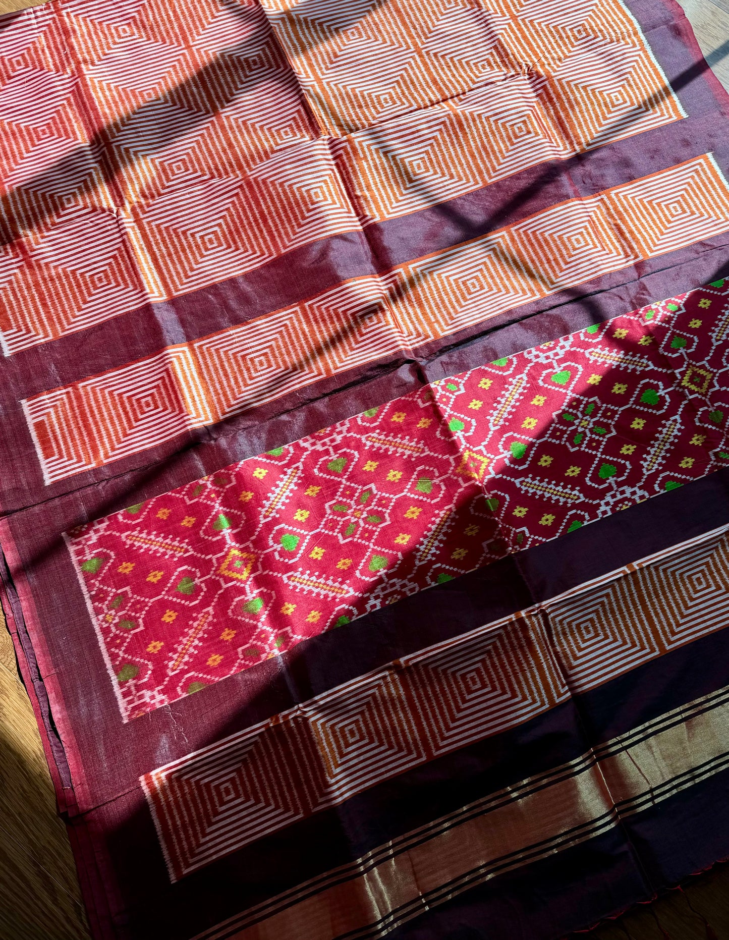 Orange and Brown combination Contemporary ikat pure silk saree with mirror effect body design